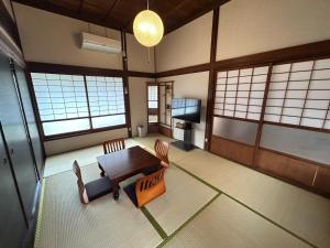 a room with a table and chairs and a television at Sakae - Vacation STAY 41407v in Goto