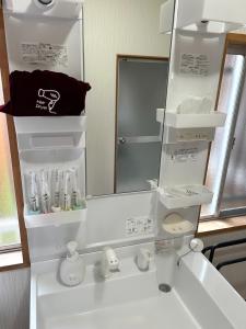 a bathroom with a white sink and a mirror at Sakae - Vacation STAY 41407v in Goto +15 photos