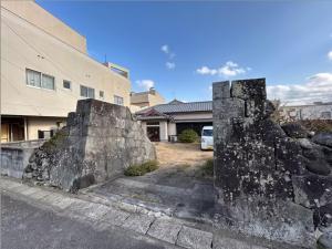 an old stone wall in front of a building at Sakae - Vacation STAY 41407v in Goto