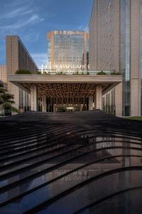 a large building with stairs in front of some buildings at Renaissance Xi'an Hotel in Xi'an