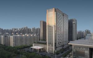 a tall building in the middle of a city at Renaissance Xi'an Hotel in Xi'an