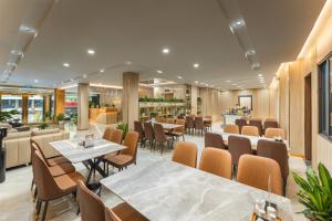 a restaurant with tables and chairs and a bar at A89 West Lake Hotel in Hanoi