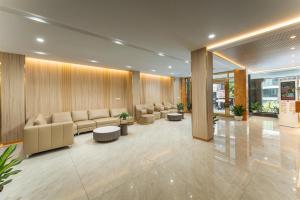 a lobby with a waiting room with couches and tables at A89 West Lake Hotel in Hanoi +289 photos