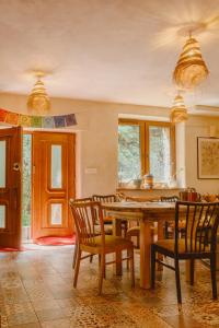 a dining room with a wooden table and chairs at DobroDziejnia in Nowa Ruda
