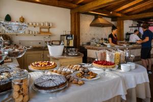 a kitchen with a table with pies and other desserts at Hotel "La Pensione Svizzera" in Taormina