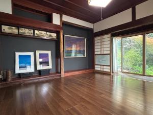an empty room with wooden floors and windows at 8co - Vacation STAY 69979v in Chino