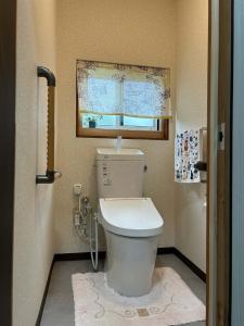 a bathroom with a toilet and a window at 8co - Vacation STAY 69979v in Chino +21 photos