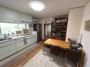 a kitchen with a wooden table and a dining room at 8co - Vacation STAY 69979v in Chino
