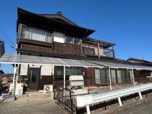a house with a balcony on top of it at 8co - Vacation STAY 69979v in Chino