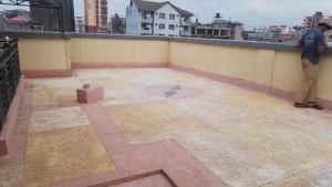 a man standing on top of a roof at Studio apartment in Ruka in Ruaka