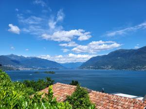 a view of a large body of water with mountains at Holiday Home Stellina del Sole by Interhome in Brissago