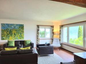 a living room with a couch and a chair at Holiday Home Stellina del Sole by Interhome in Brissago +27 photos