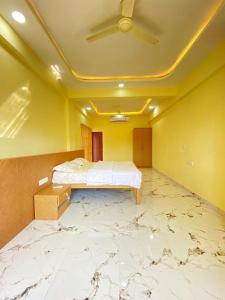 a bedroom with a bed with a marble floor at Beach Walk - By Blue waves in Alībāg
