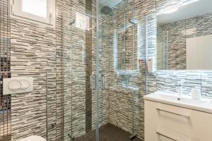 a bathroom with a glass shower and a sink at Villa Loznati in Cres +26 photos