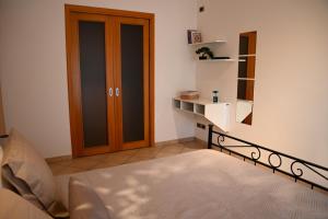 a bedroom with a bed and a wooden door at Il Sogno di Ilaria in Arezzo