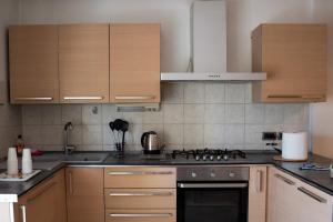 a kitchen with wooden cabinets and a stove top oven at Il Sogno di Ilaria in Arezzo
