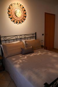 a bedroom with a bed with a clock on the wall at Il Sogno di Ilaria in Arezzo +9 photos
