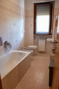 a bathroom with a tub and a toilet and a sink at Il Sogno di Ilaria in Arezzo
