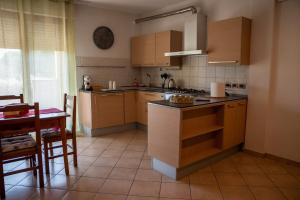a kitchen with wooden cabinets and a table and a tableablish at Il Sogno di Ilaria in Arezzo