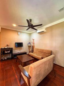 a living room with a couch and a ceiling fan at Rivora Gopeng in Gopeng +15 photos