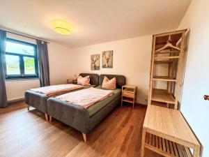a bedroom with a bed and a book shelf at Apartment Bornholm by Interhome in Dargun