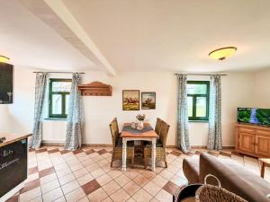 a living room with a table and chairs at Apartment Bornholm by Interhome in Dargun +16 photos