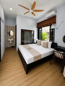 a bedroom with a large bed and a ceiling fan at Hue Ancient Hostel in Hue