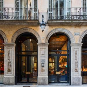a store front with three arched windows and a building at Hotel España Ocean Drive - Newly Renovated in Barcelona