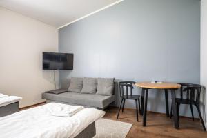 a living room with a couch and a table at LODGE Hostel Kuusamo in Kuusamo