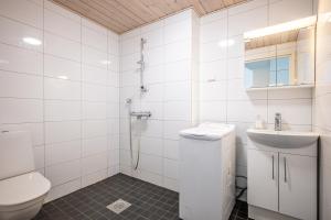 a white bathroom with a toilet and a sink at LODGE Hostel Kuusamo in Kuusamo +27 photos