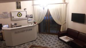 a hotel room with a lobby with a couch and a door at Süreyya Hanım Otel in İzmir