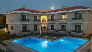a large house with a swimming pool in front of it at Süreyya Hanım Otel in İzmir