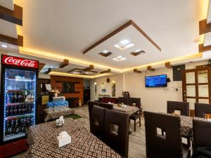 a restaurant with tables and chairs and a soda machine at Apartment Hotel 11 Thamel in Kathmandu