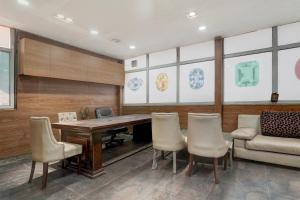 a conference room with a wooden table and chairs at Townhouse Millenium City Centre in Gurgaon