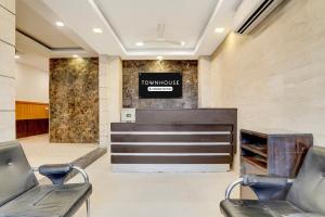 a lobby with two chairs and a reception desk at Townhouse Millenium City Centre in Gurgaon