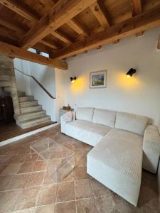 a living room with a white couch and stairs at Cuq en Terrasses in Cuq-Toulza +51 photos