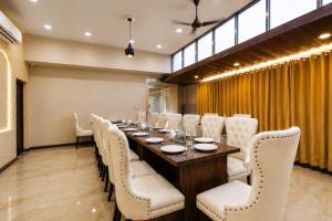 a conference room with a long table and white chairs at Hotel Tamanna 2 Minute Walk from Golden Temple in Amritsar