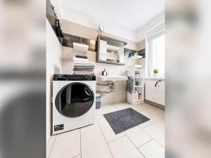 a kitchen with a washing machine and a sink at Apartment Wohnung „Sonnendeck“ by Interhome in Laupheim