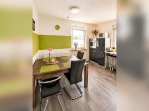 a kitchen and dining room with a table and chairs at Apartment Wohnung „Sonnendeck“ by Interhome in Laupheim