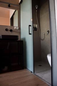 a bathroom with a shower with a sink and a toilet at L7 Urban Studios in Tel Aviv +7 photos