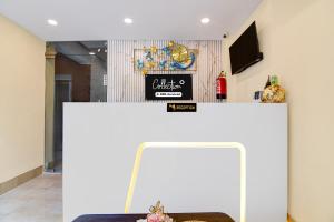 a white counter with a couch and a tv at Super Collection O Newtown Bus Stand Formerly The Executive Suites in New Town