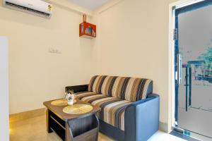 a living room with a couch and a table at Super Collection O Newtown Bus Stand Formerly The Executive Suites in New Town