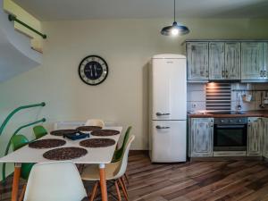 a kitchen with a table and a white refrigerator at Petra & Thalassa in Plataria