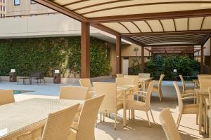 an outdoor seating area with tables and chairs at Perugia Plaza Hotel in Perugia
