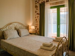 a bedroom with a bed with two towels on it at Petra & Thalassa in Plataria +77 photos