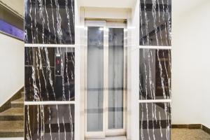 a glass door with icicles on the side of a building at Super Townhouse Raniganj Formerly Devi Residency in Hyderabad