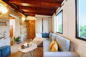 a living room with a couch and a table at Villa Anthemida Chania in Ayiá
