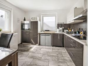 a kitchen with stainless steel appliances and a tile floor at Holiday Home Bailey by Interhome in Laupheim