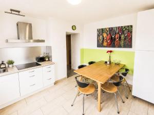 a kitchen with a wooden table and chairs at Holiday Home Bailey by Interhome in Laupheim