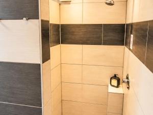 a bathroom with a shower with a glass door at Apartment Wohnung Gartenblick by Interhome in Laupheim